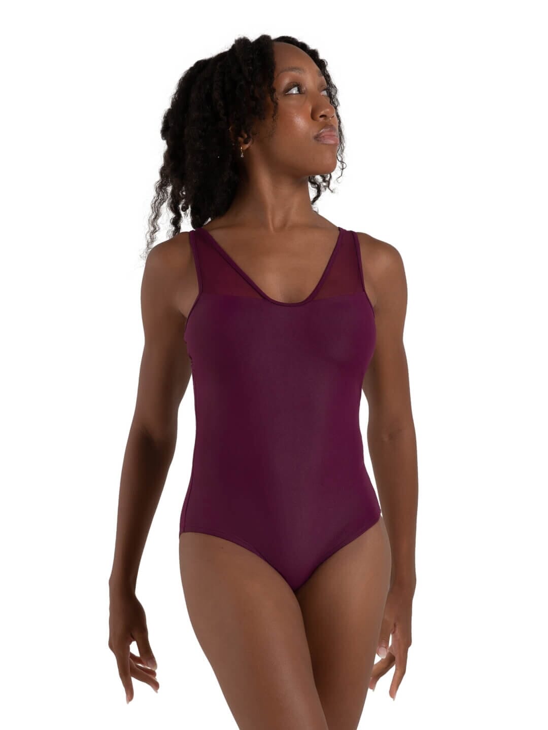 Woman wearing a purple bodysuit on a white background