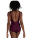 Person wearing a burgundy swimsuit with a plain background