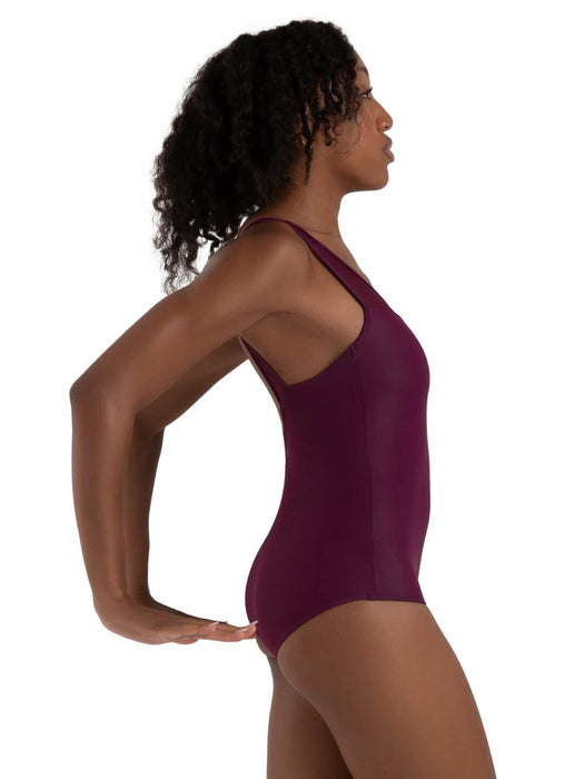 Woman wearing a purple swimsuit against a white background