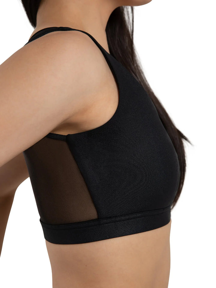 Black sports bra worn by a person on a white background