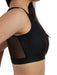 Black sports bra worn by a person on a white background