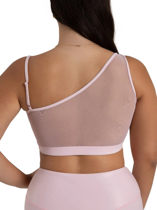 Woman wearing a light pink mesh top on a white background