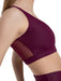 Maroon sports bra with mesh panels on a white background