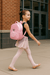 Little girl dancer with pink backpack walking to dance class
