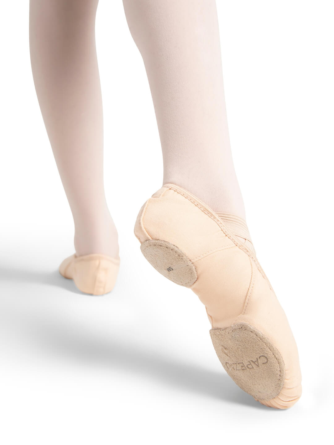 Ballet shoes worn with tights on a white background