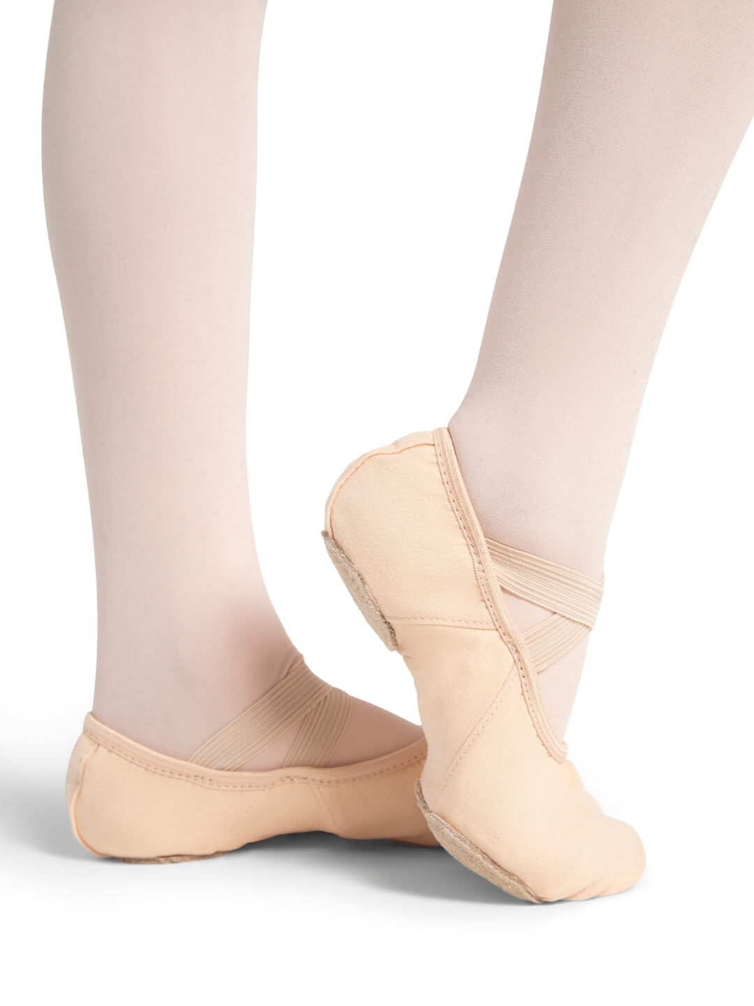 Ballet shoes worn with tights on a white background