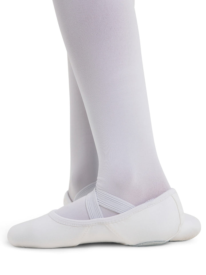White ballet shoes worn with white tights on a white background