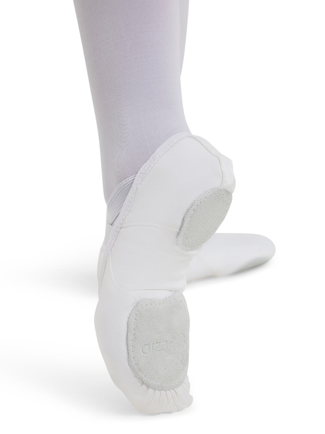 White ballet shoes worn with white tights on a white background