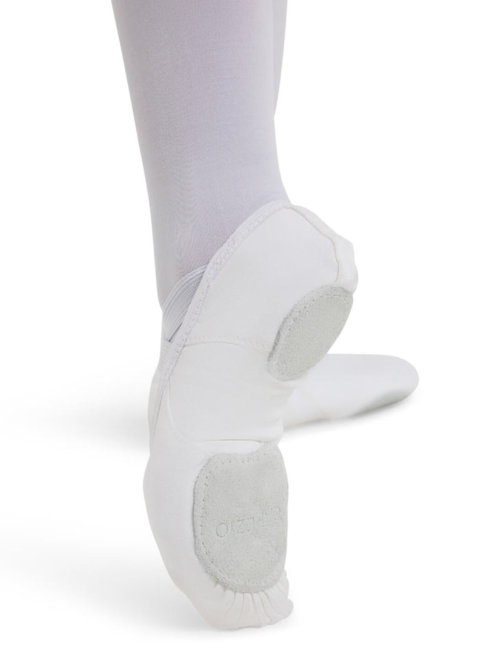White ballet shoes worn with white tights on a white background