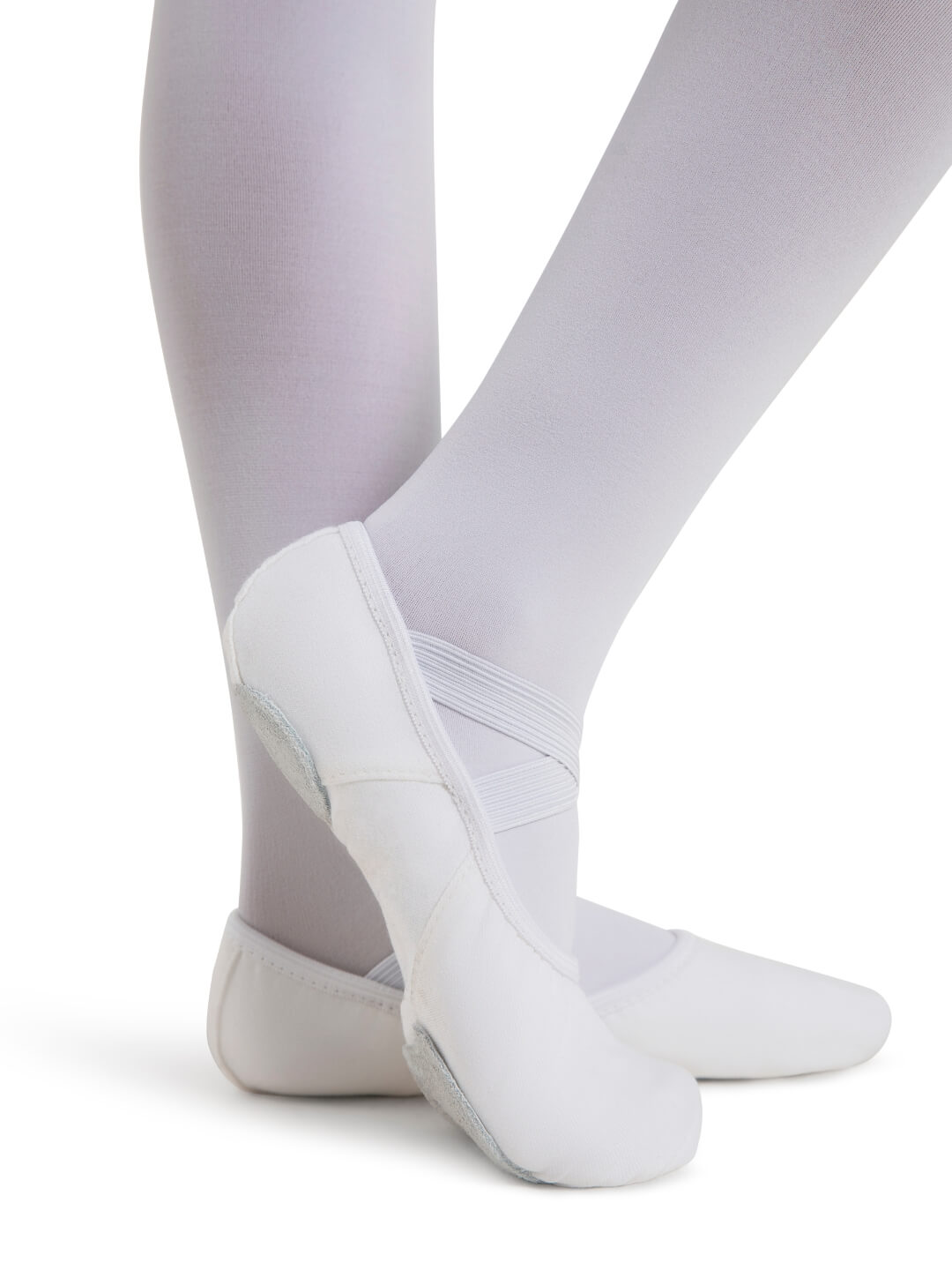 White ballet shoes worn with white tights on a white background