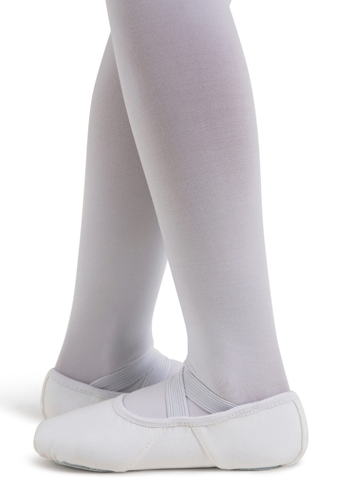 White ballet shoes and tights on a white background