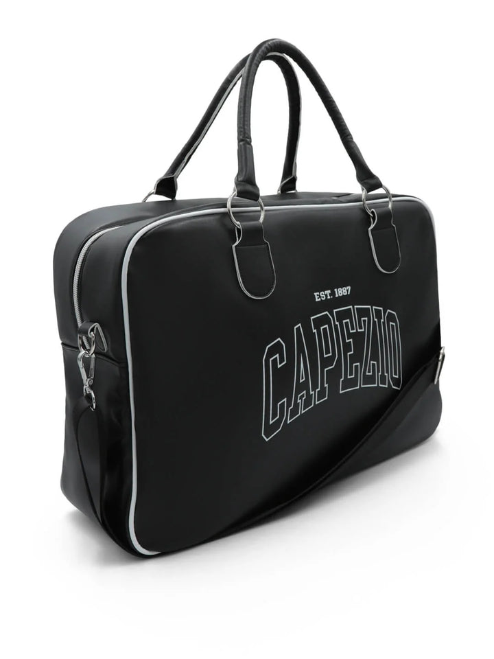 A black leather briefcase with white piping and 'CAPEZIO' printed in white outline letters on the front, featuring dual top handles and a shoulder strap, set against a plain white background.