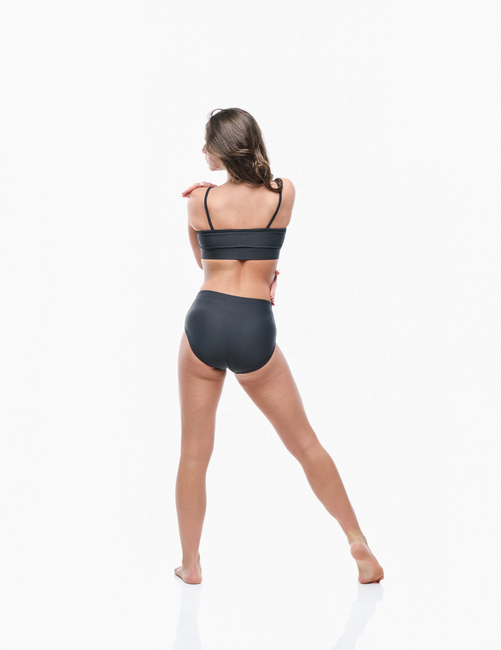 Woman wearing a black bikini on a white background