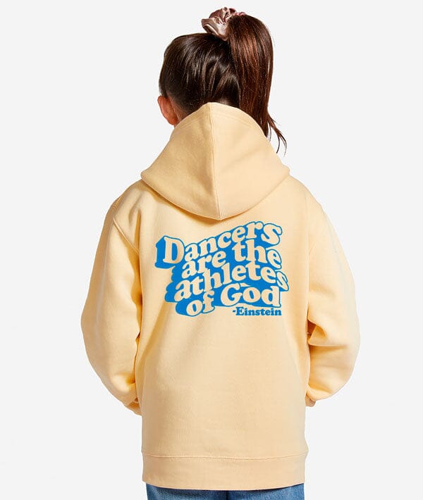Person wearing a yellow dance hoodie with blue text on the back, Dancers are the athletes of God standing against a white background