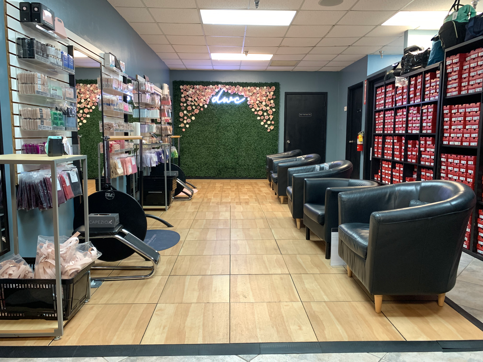 Pointe Shoe Fitting area with black leather chairs and product displays in the DWC store setting