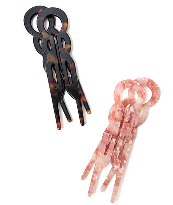 Two hair clips, one tortoiseshell and one pink, on a white background