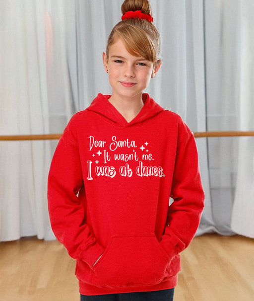 Child wearing a red hoodie with text in a dance studio