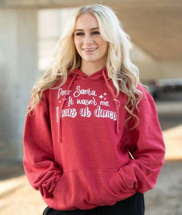 Person wearing a red hoodie with text, standing outdoors.