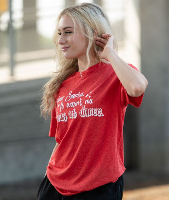 Woman wearing a red t-shirt with white text outdoors