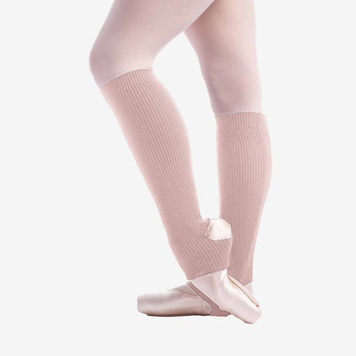 Ballet dancer wearing pink tights and ballet shoes on a white background