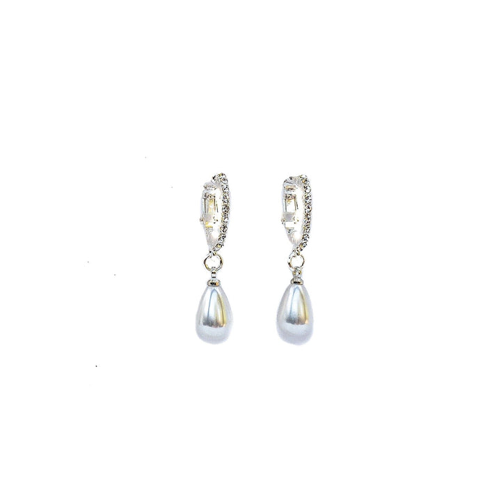 Pair of silver earrings with teardrop-shaped pearls on a white background