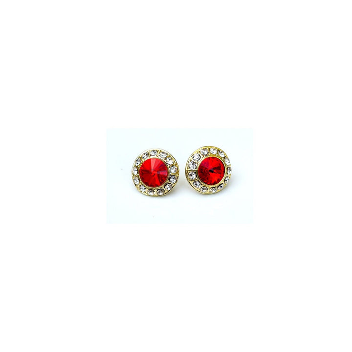 Pair of round earrings with red gemstones and gold accents on a white background