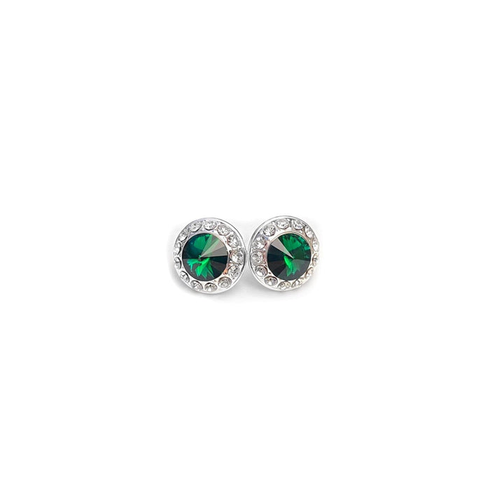Silver earrings with green gemstones on a white background