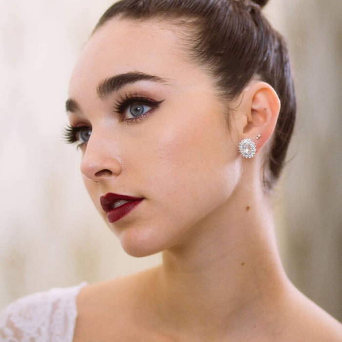 Close-up of a woman wearing a diamond earring with a blurred background