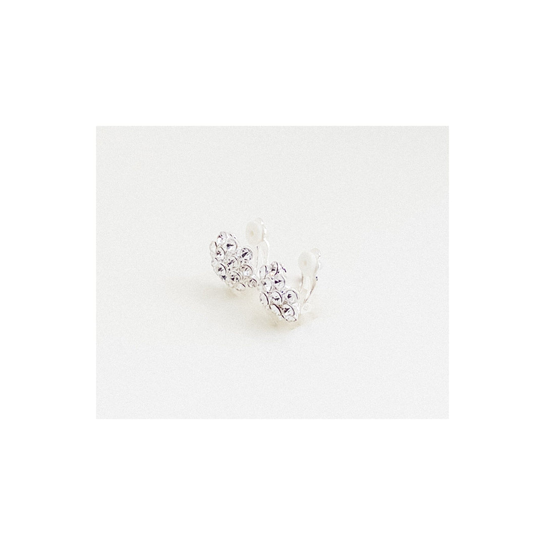 Silver heart-shaped earring on a white background