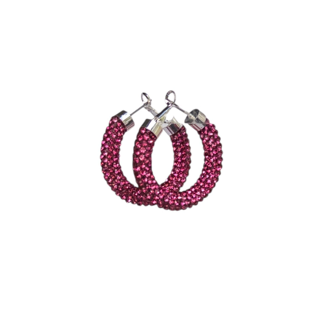 Pink hoop earrings with rhinestone detailing on a white background
