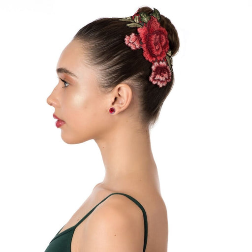 Woman wearing a floral hair accessory on a white background