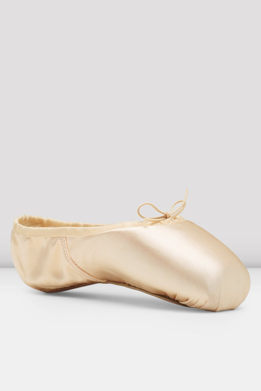 Beige ballet shoe on a light gray background