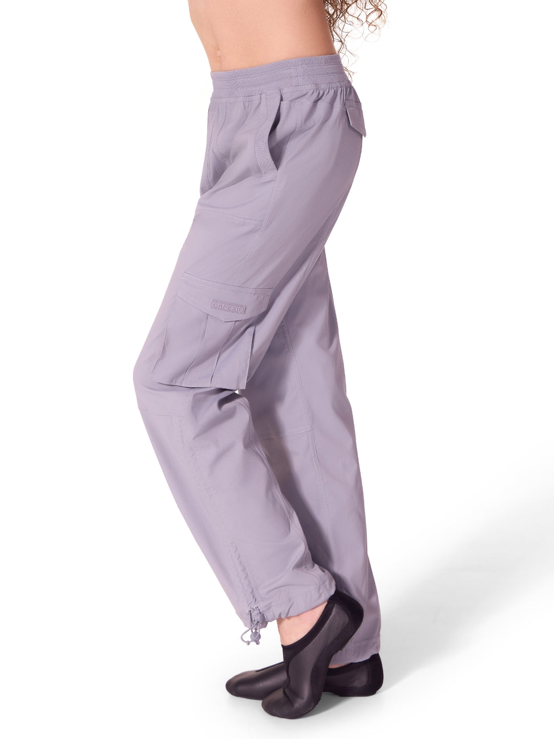 Purple pants worn by a person on a white background