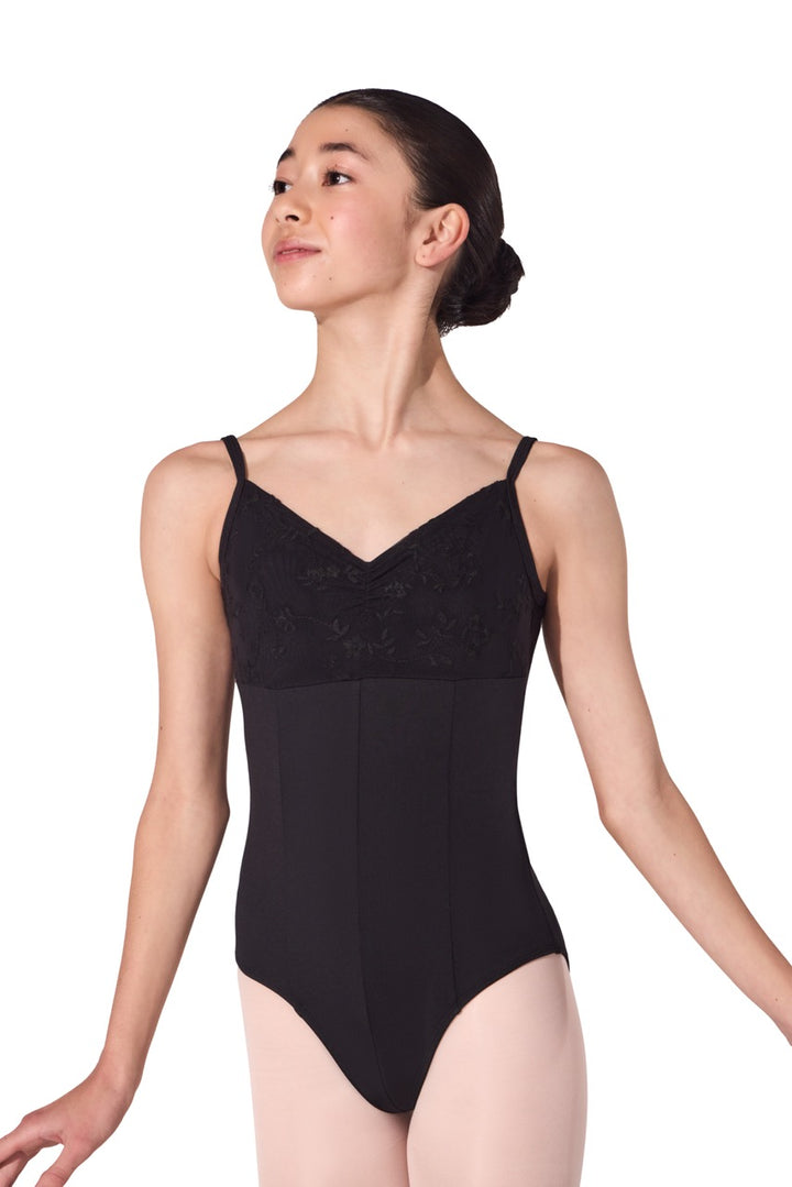 A female dancer wearing a black bodysuit leotard with thin shoulder straps, photographed against a plain white background.
