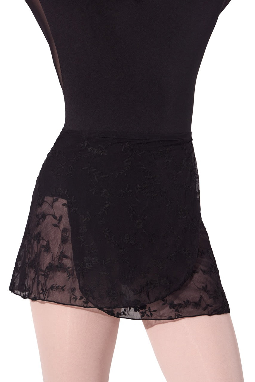 Black dance skirt with floral lace overlay and sheer mesh side panels, shown on a mannequin against a white background.