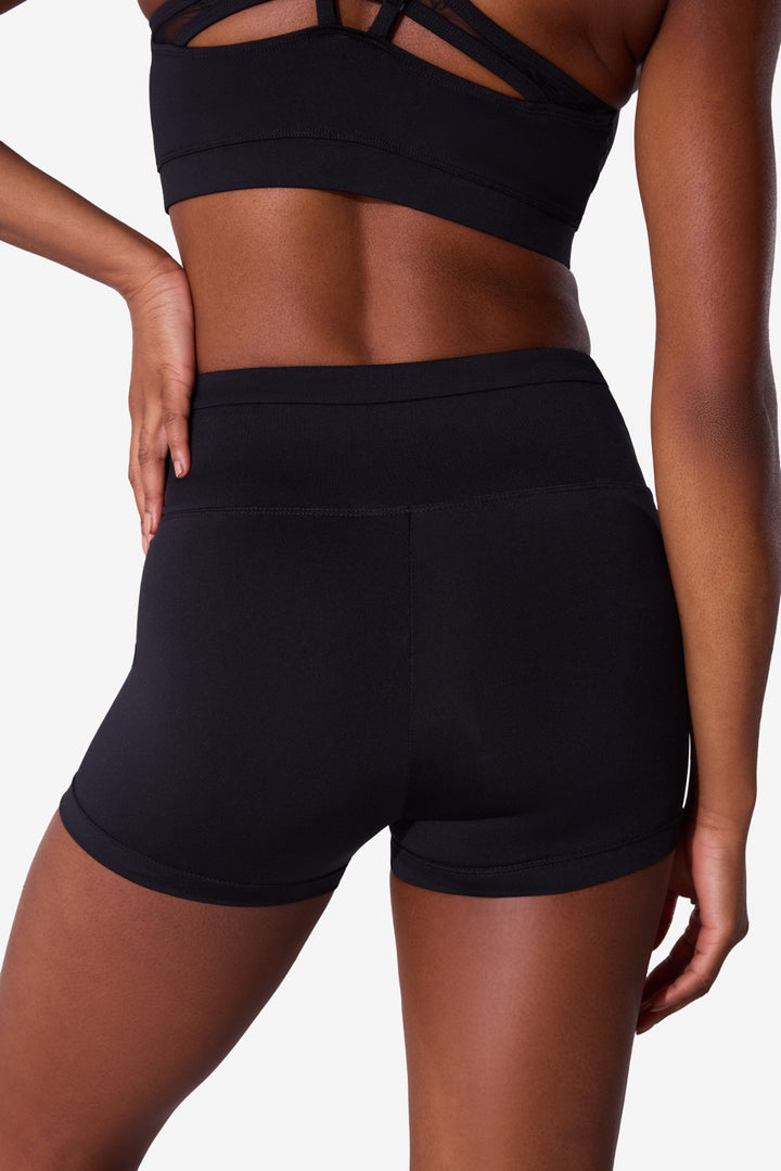 Black athletic shorts with a high waistband and side pockets, shown on a model from the back against a light gray background.