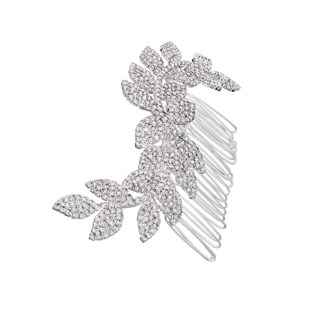 Silver hair comb with leaf-like designs on a white background