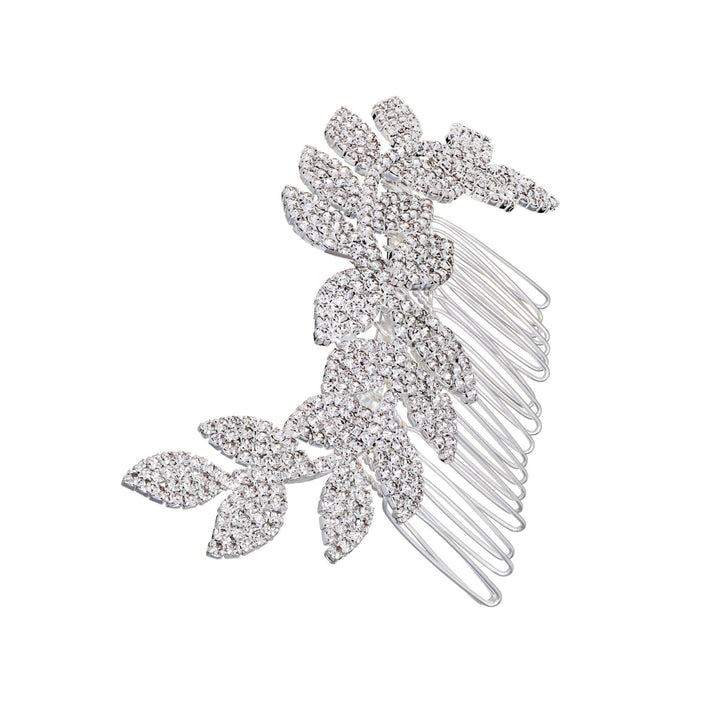 Silver hair comb with leaf-like designs on a white background