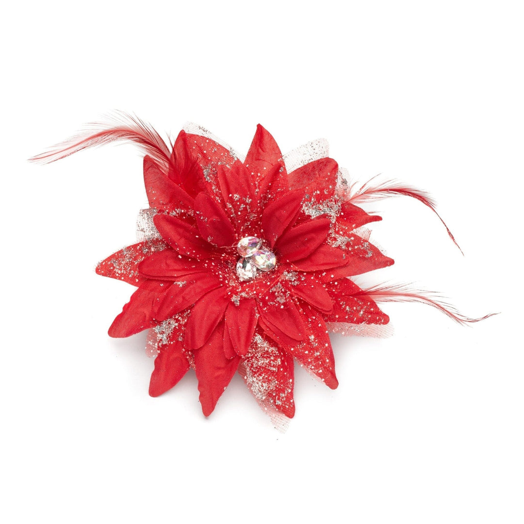 Red flower accessory with feathers on a white background