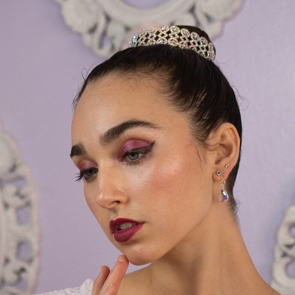 Woman wearing a tiara with a decorative background
