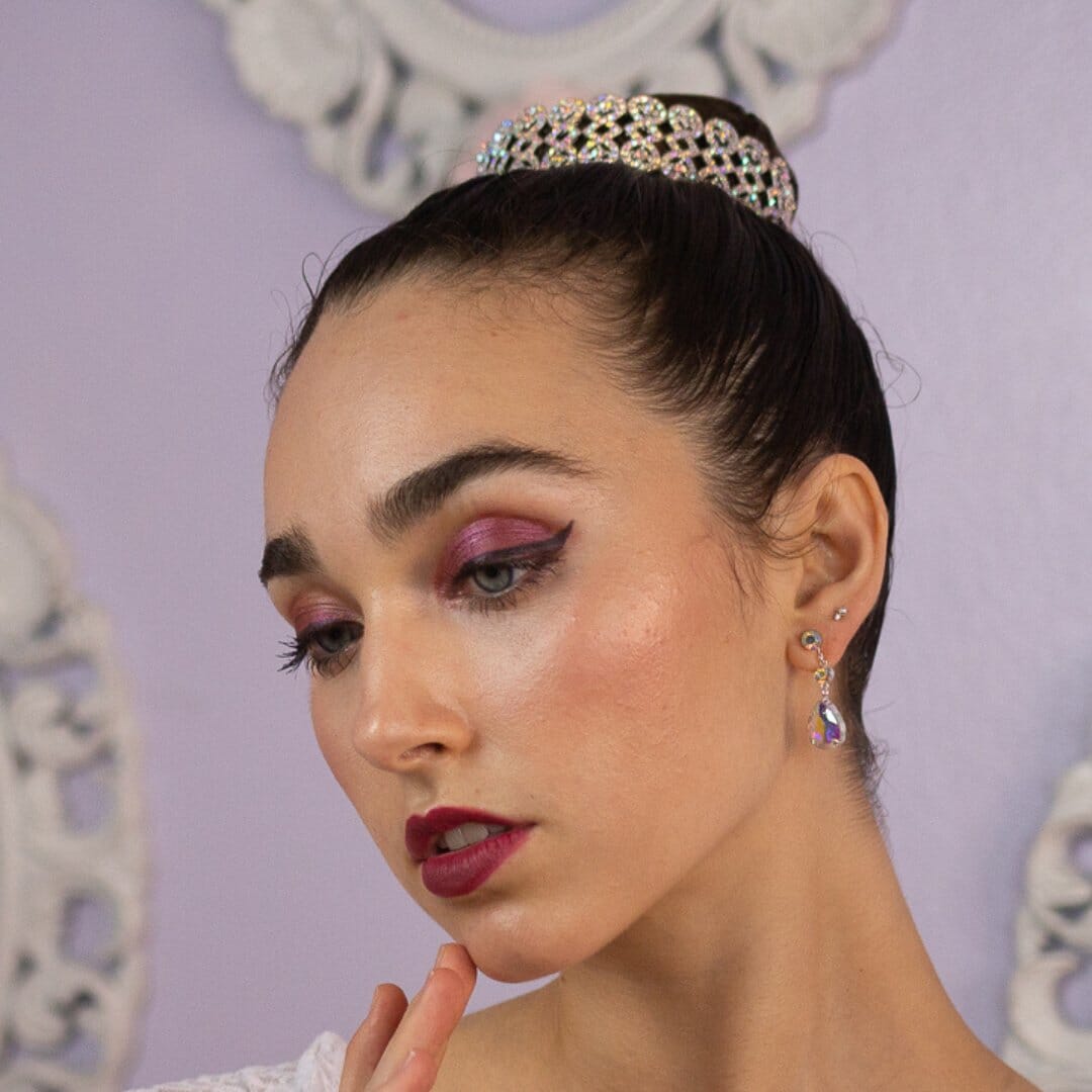 Woman wearing a tiara with a decorative background