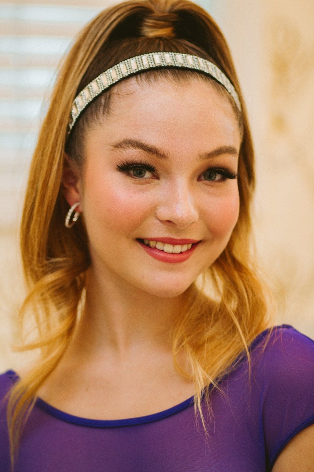 Woman wearing a headband and smiling outdoors