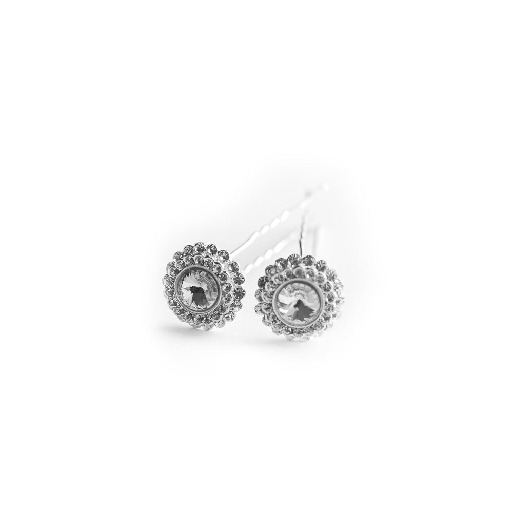 Silver earrings with circular designs on a white background