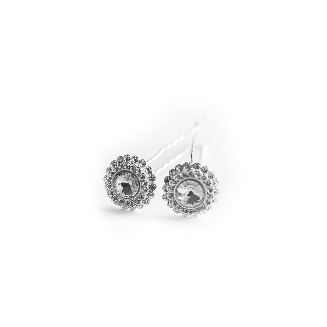 Silver earrings with circular designs on a white background