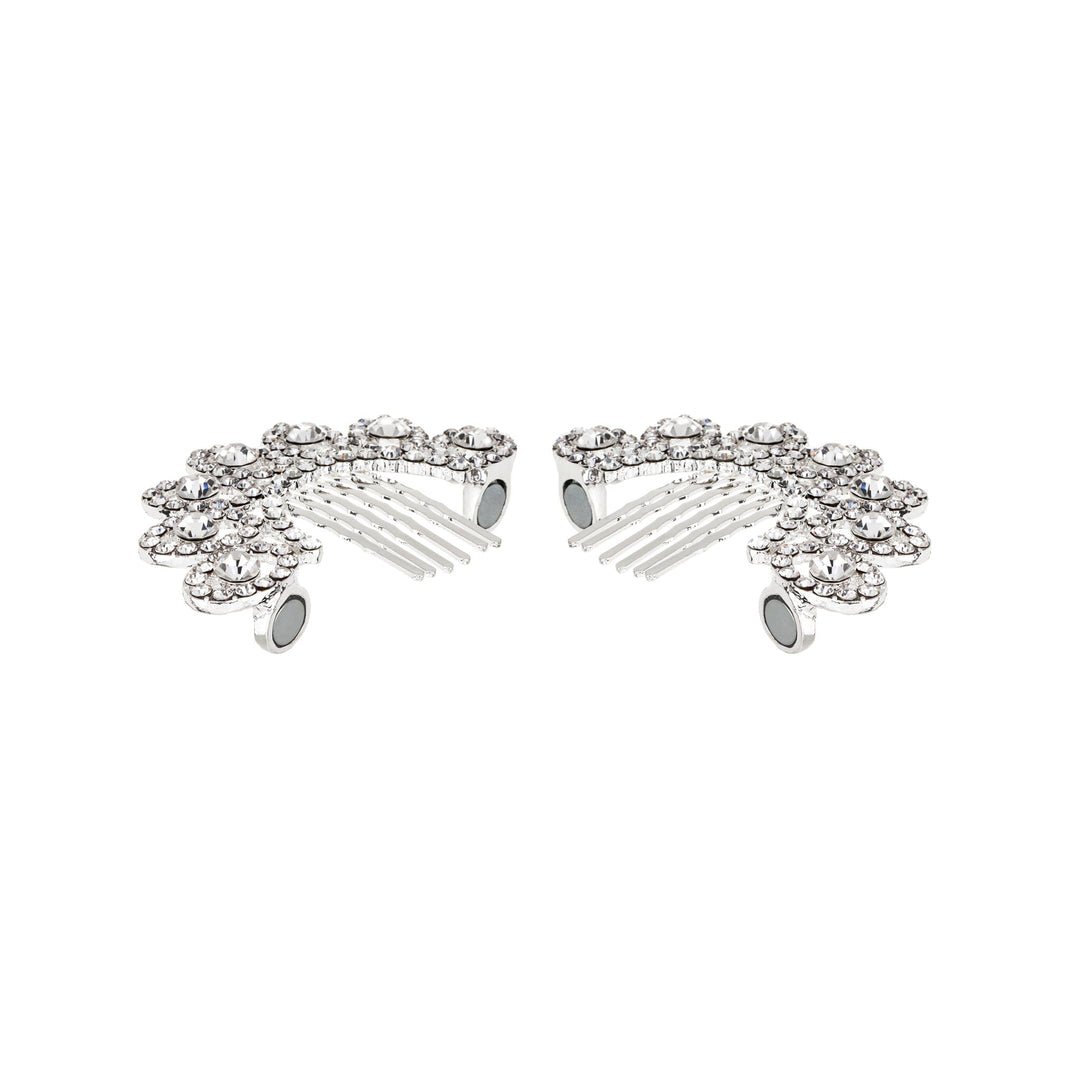 Silver hair combs with gemstones on a white background