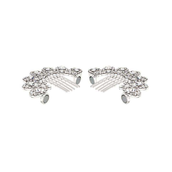 Silver hair combs with gemstones on a white background