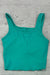 Green tank top on a textured gray surface