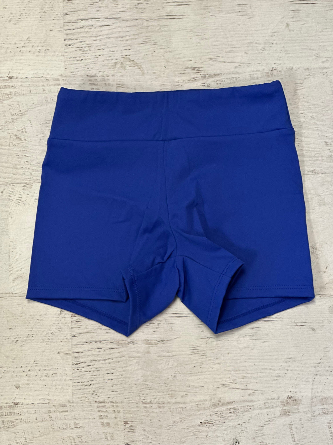Blue shorts on a textured beige surface