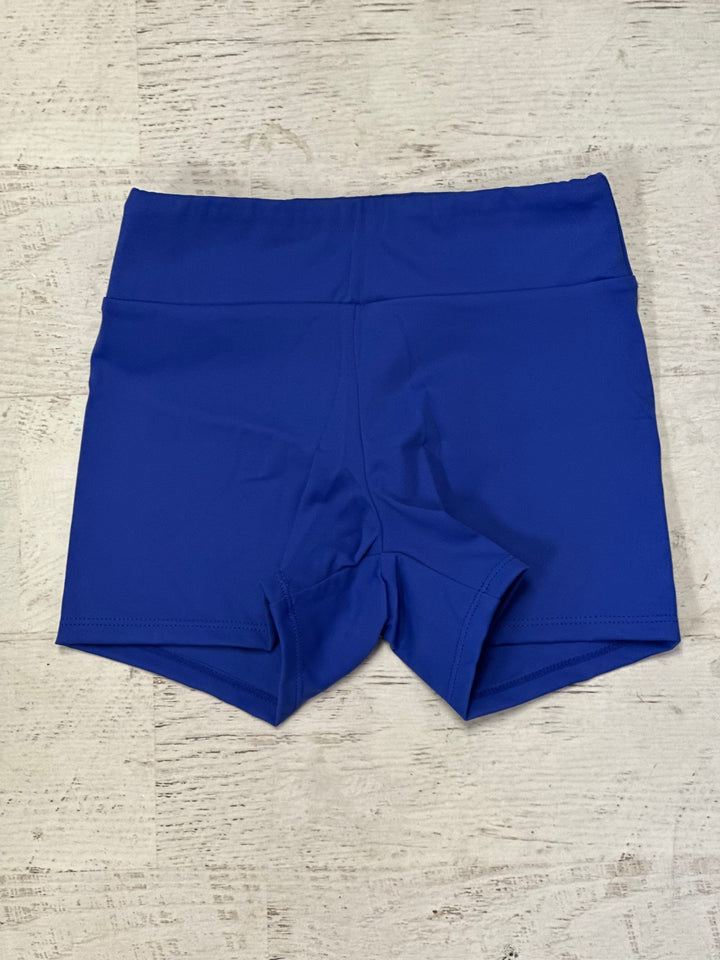 Blue shorts on a textured beige surface