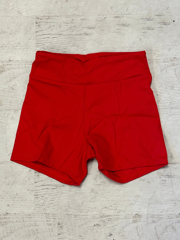 Red shorts on a light wooden surface